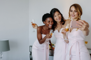 Bachelorettes drinking and taking selfies before the wedding.