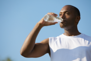 Man drinking water for muscle recovery rehydration