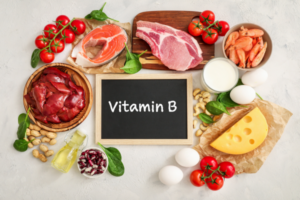 Foods rich in B Complex vitamins including whole grains, leafy greens, and lean meats.