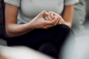 Person picking nails, showcasing anxiety symptoms before IV therapy.