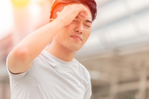 Man suffering from a dehydration-related headache