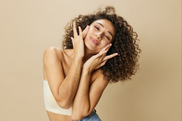 Woman with curly, moisturized hair. Vitamin C may give hair moisturization and shine to all looks of hair types.