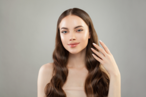 A lady showing off beautiful, luscious hair to depict the advantage of Vitamin C, which thickens hair strands, thus making it stronger and healthier.