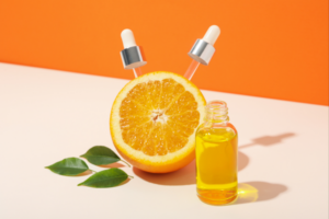 Vitamin C serum and orange symbolizing fast recovery and muscle repair benefits of Vitamin C for athletes.