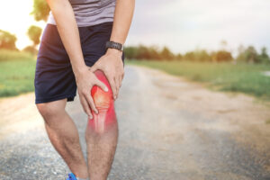 A person experiencing knee inflammation, a common issue treatable with IV therapy for inflammation relief.