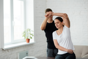 Athlete engaging in muscle recovery through assisted stretching, a key method to reduce soreness and enhance flexibility.