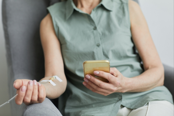 Woman receiving IV therapy at home in under 60 minutes.