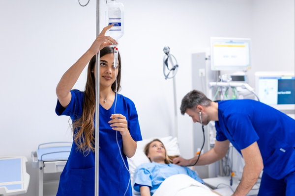 a nurse setting up an IV drip in a hospital.