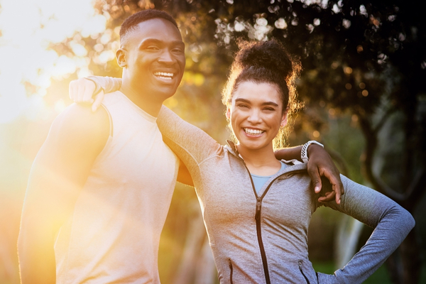 A happy and energized couple outdoors after IV therapy.